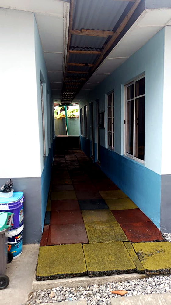 Covered walkway with rainbow tiles in the primary block