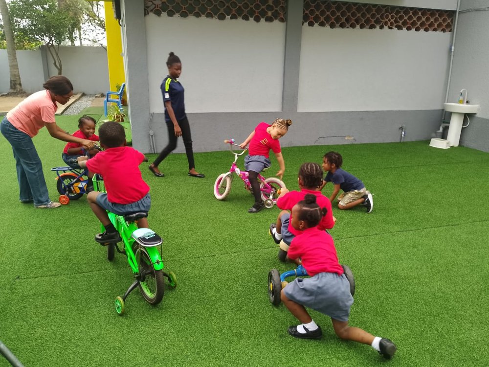 Children playing outdoors at Flourish Playhouse in Festac Town, Lagos