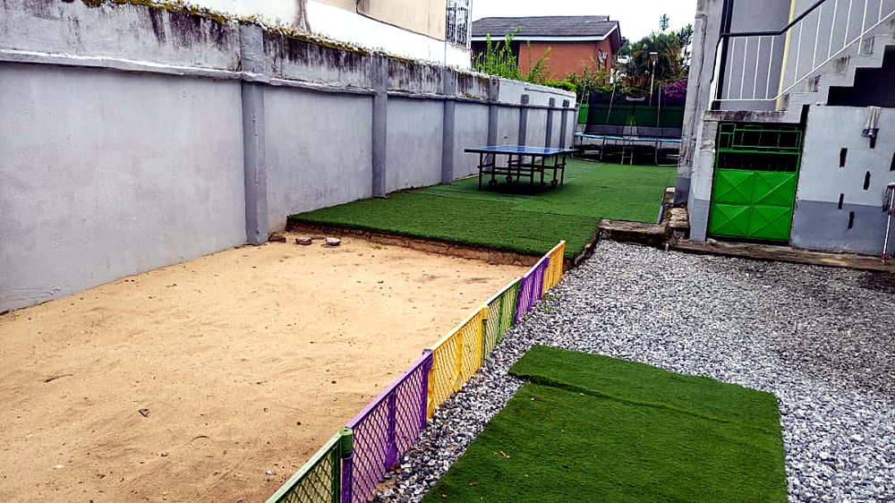 Playground with sand area, table tennis and trampoline at Flourish Playhouse
