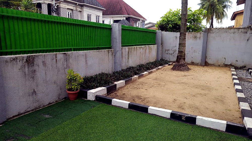 Sand pit beside the green fence at Flourish Playhouse